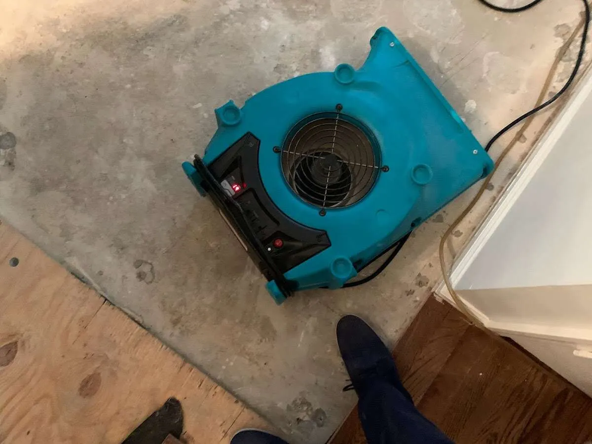 Air mover drying subfloor during Leak Detection & Repair in South Kingstown